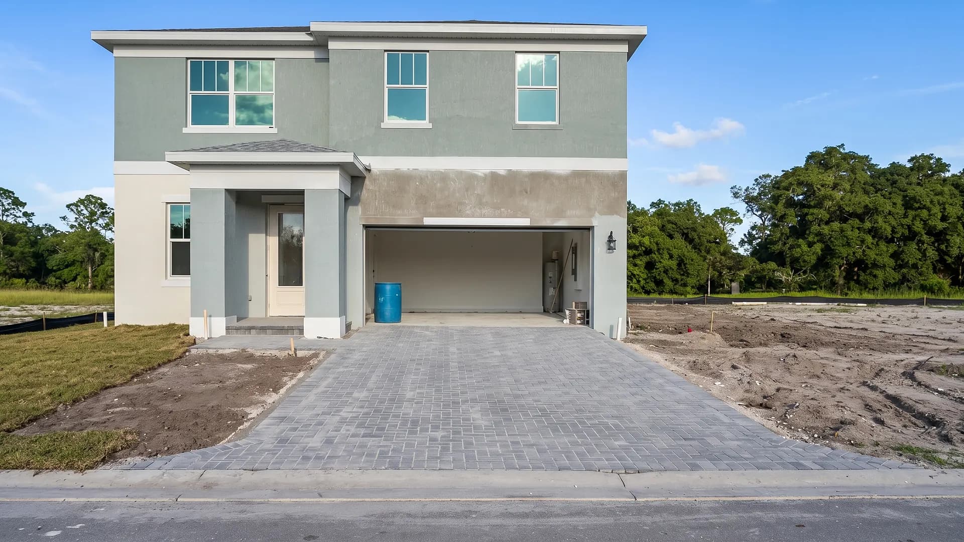 Grey herringbone paver driveway at a new construction home