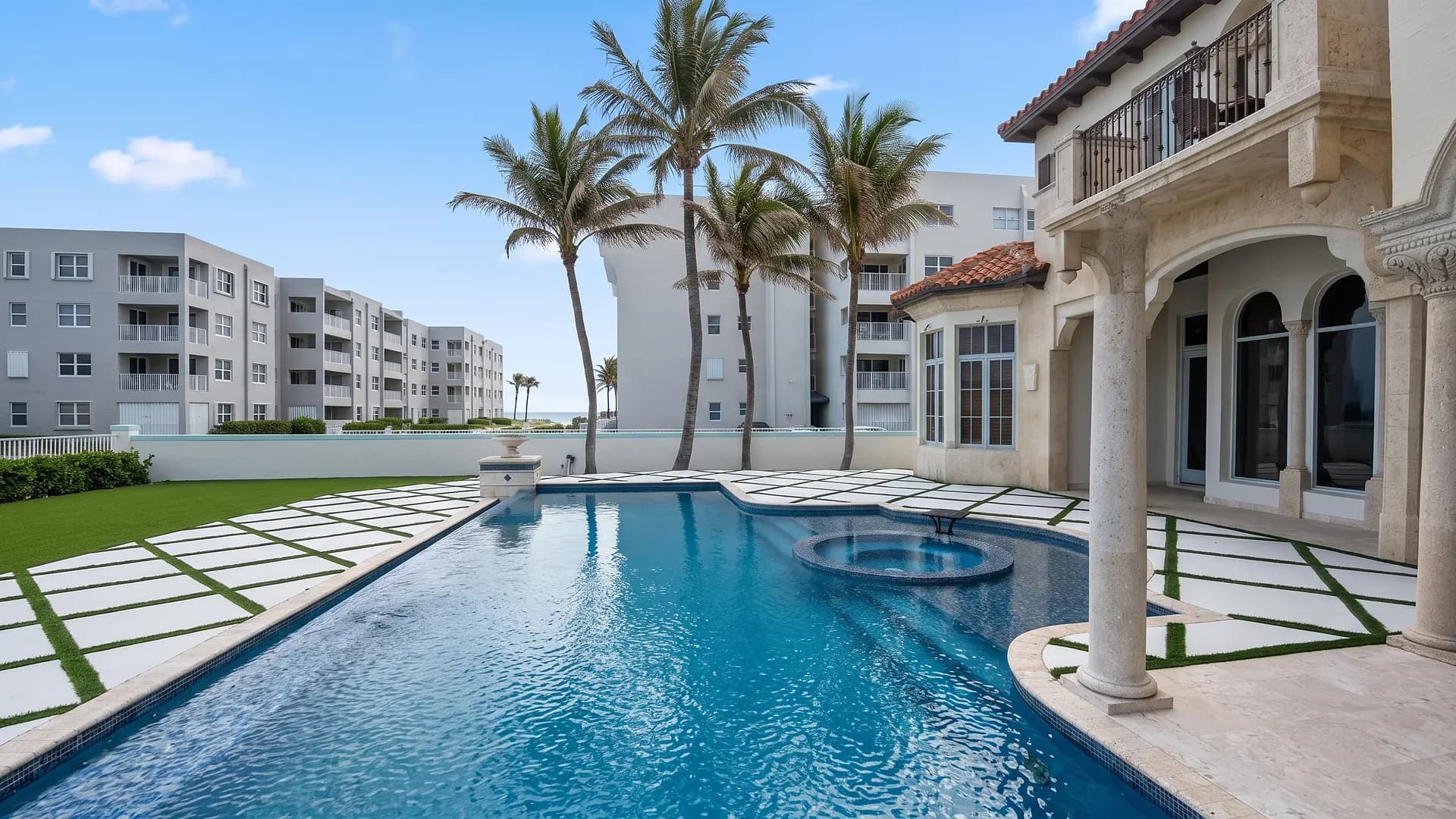 Oceanfront pool deck with white pavers and turf joints